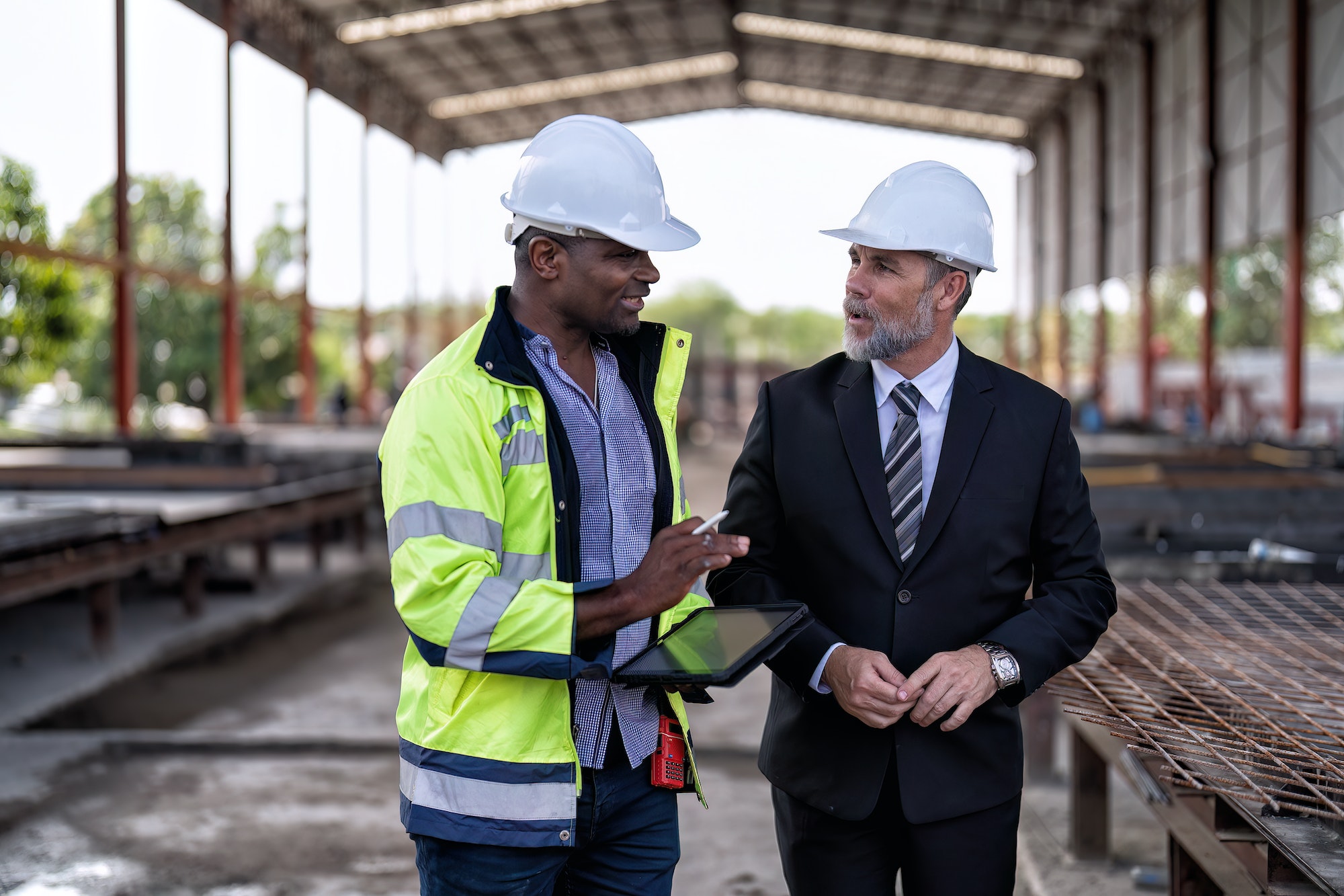 At construction site manager meet engineer check precast concrete slabs and steel rebar preparation